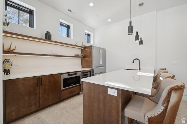 7242 Lupine Dr, Park City, UT 84098 - kitchen featuring open shelves, freestanding refrigerator, a sink, a breakfast bar area, and dark brown cabinets