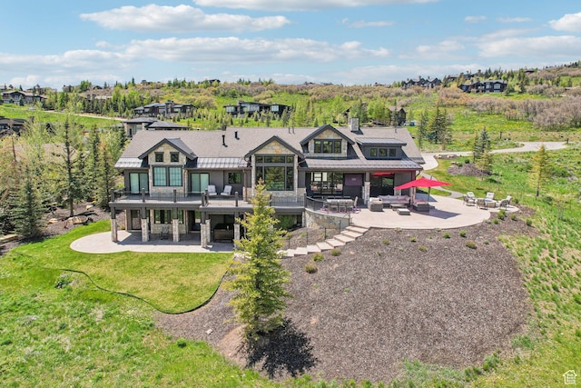 7242 Lupine Dr, Park City, UT 84098 - back of house with a patio, stone siding, a chimney, and metal roof