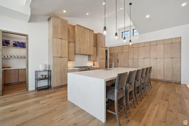 7242 Lupine Dr, Park City, UT 84098 - kitchen featuring modern cabinets, a sink, light wood-style floors, light countertops, and high vaulted ceiling