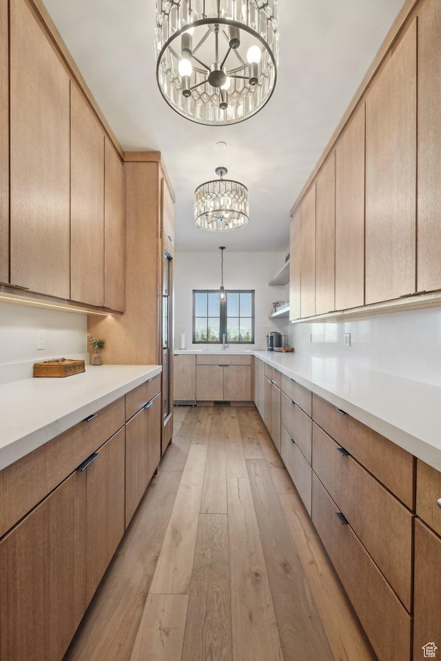 7242 Lupine Dr, Park City, UT 84098 - kitchen with a chandelier, light countertops, light brown cabinetry, light wood-style floors, and open shelves