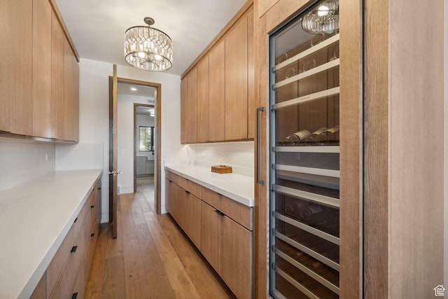 7242 Lupine Dr, Park City, UT 84098 - kitchen with light wood-style floors, light countertops, a chandelier, and modern cabinets