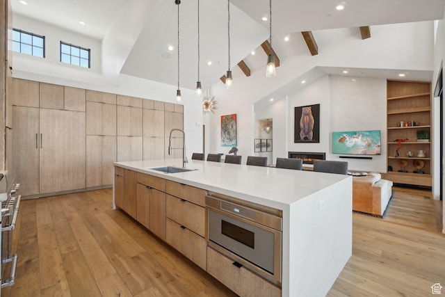 7242 Lupine Dr, Park City, UT 84098 - kitchen with a sink, modern cabinets, open floor plan, light wood finished floors, and beamed ceiling