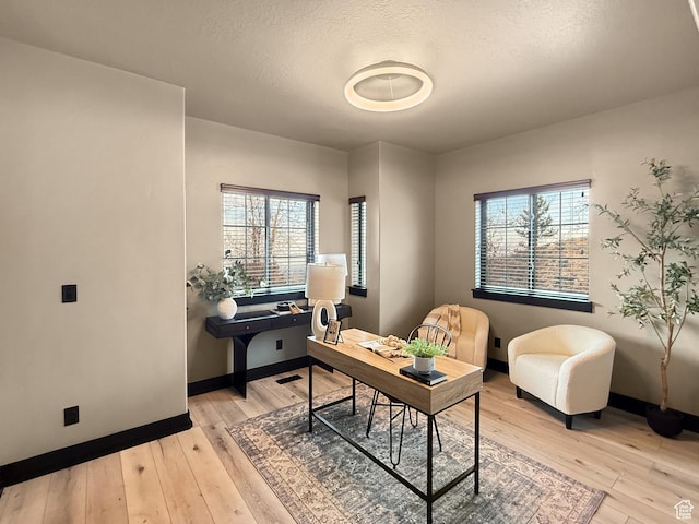 office with baseboards and light wood-type flooring
