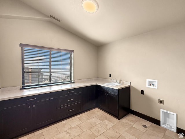 washroom with a sink, cabinet space, hookup for an electric dryer, visible vents, and washer hookup