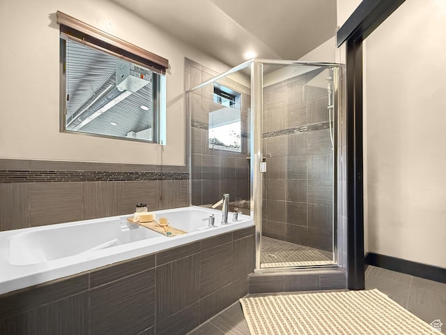 full bath featuring a garden tub, tile patterned flooring, and a stall shower