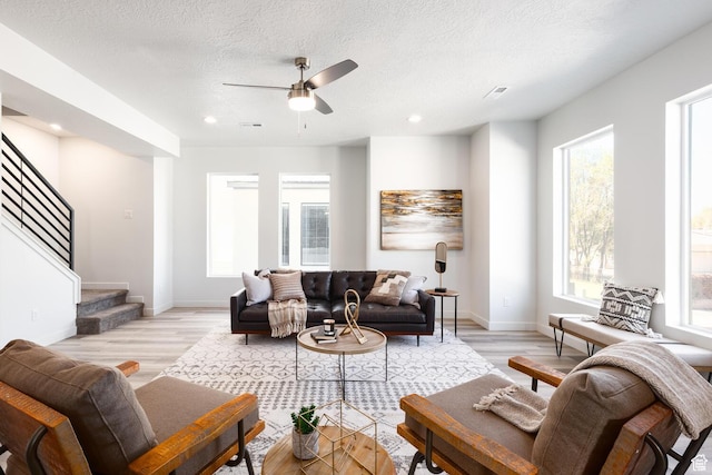 328 E 3390 S Unit 11, South Salt Lake, UT 84115 - living room featuring ceiling fan, plenty of natural light, a textured ceiling, and light wood-type flooring