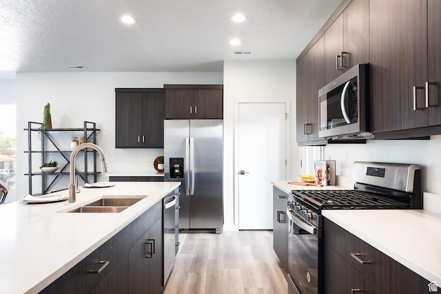 328 E 3390 S Unit 11, South Salt Lake, UT 84115 - kitchen featuring appliances with stainless steel finishes, sink, light hardwood / wood-style floors, and dark brown cabinets