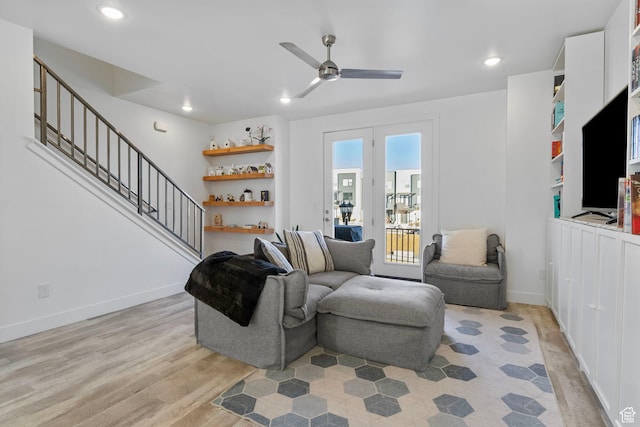 living room featuring ceiling fan and light hardwood / wood-style flooring