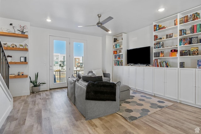 living room with ceiling fan and light hardwood / wood-style flooring
