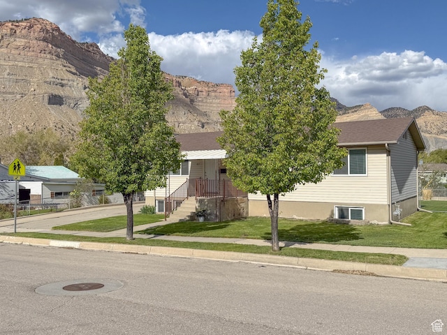 87 Bryner St, Helper, UT 84526 - obstructed view of property featuring a mountain view, a front yard, and central AC