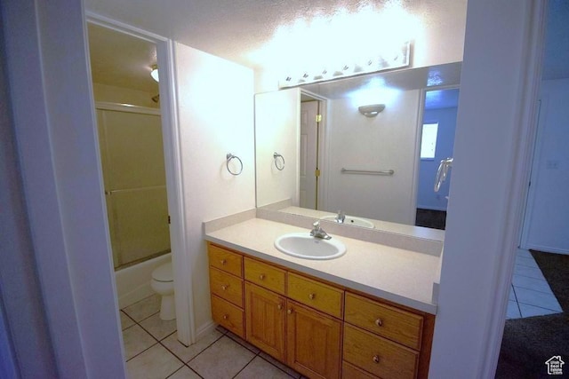 full bathroom with toilet, vanity, shower / bath combination with glass door, and tile patterned flooring