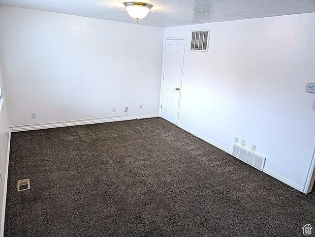 carpeted spare room featuring a textured ceiling
