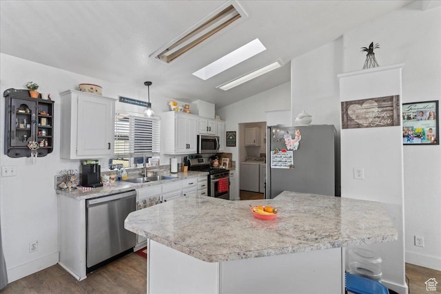 5507 S 1150 W, Riverdale, UT 84405 - kitchen with appliances with stainless steel finishes, washer and clothes dryer, a skylight, a sink, and lofted ceiling