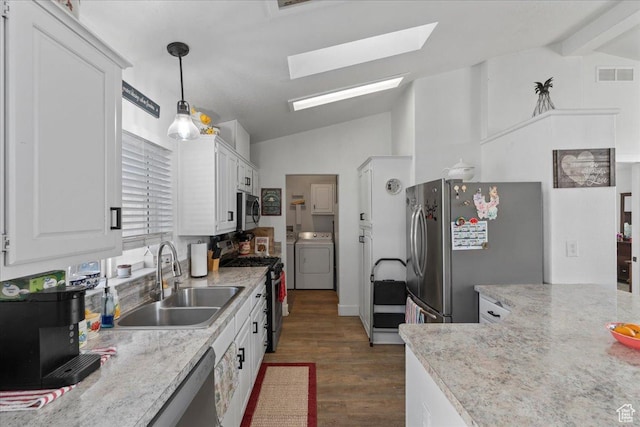 5507 S 1150 W, Riverdale, UT 84405 - kitchen featuring appliances with stainless steel finishes, a sink, a skylight, wood finished floors, and white cabinetry
