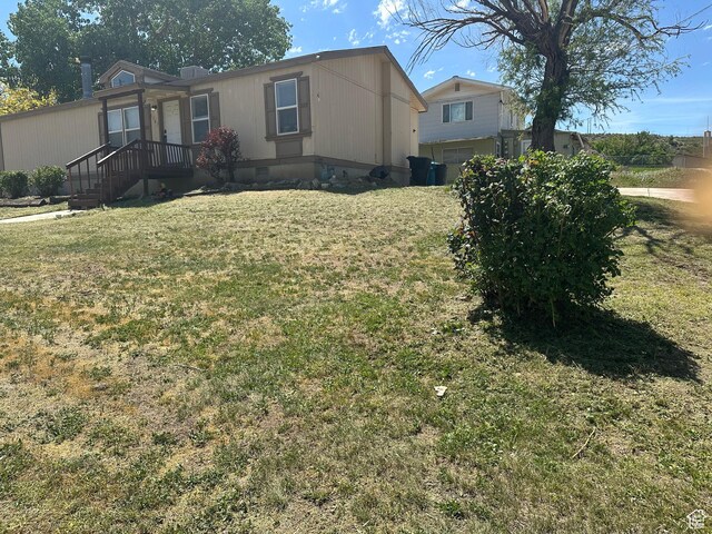 5507 S 1150 W, Riverdale, UT 84405 - view of front of home featuring a front lawn