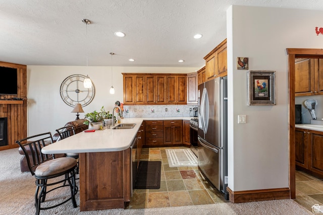 337 E Brayden Way, Draper, UT 84020 - kitchen with a kitchen bar, sink, kitchen peninsula, pendant lighting, and stainless steel appliances