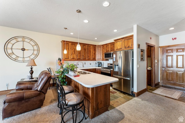 337 E Brayden Way, Draper, UT 84020 - kitchen with sink, a breakfast bar area, appliances with stainless steel finishes, decorative light fixtures, and kitchen peninsula