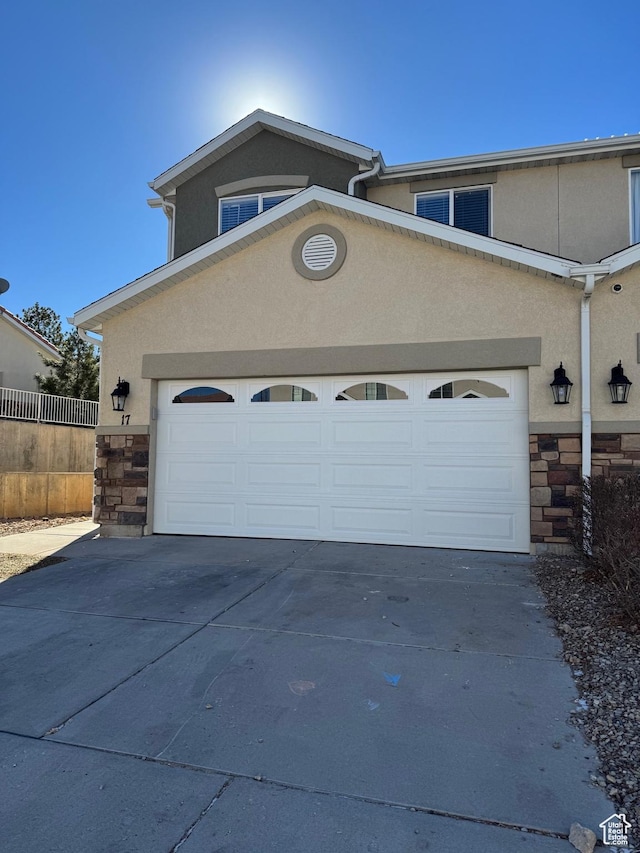 173 E Fidllers Canyon Rd Unit 17, Cedar City, UT 84721 - garage featuring concrete driveway and fence