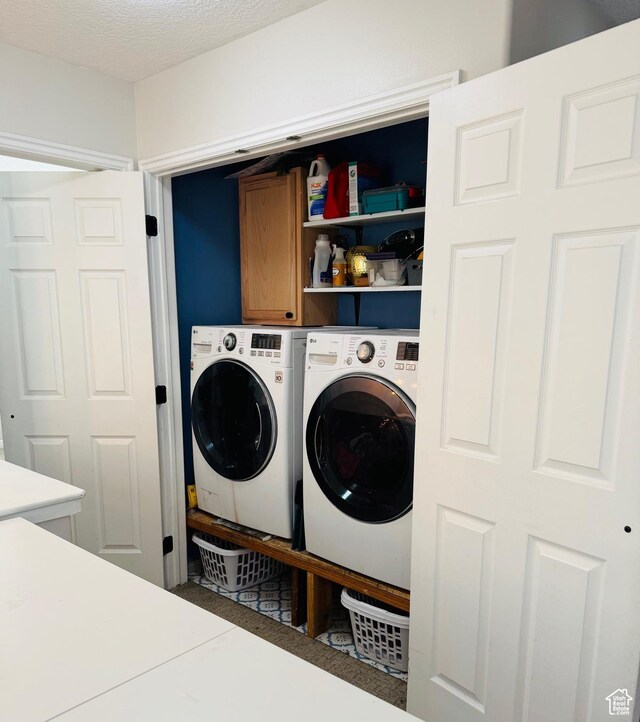 173 E Fidllers Canyon Rd Unit 17, Cedar City, UT 84721 - clothes washing area featuring cabinet space, a textured ceiling, and washing machine and clothes dryer