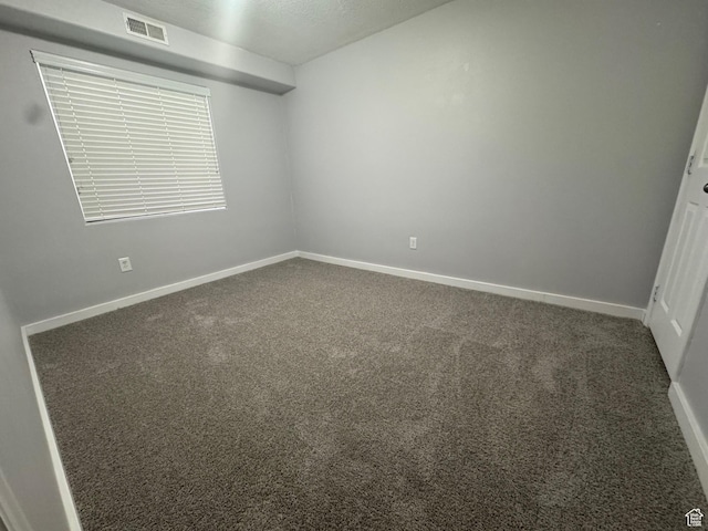 173 E Fidllers Canyon Rd Unit 17, Cedar City, UT 84721 - empty room featuring visible vents, baseboards, and carpet flooring