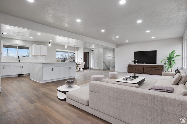1455 E 100 S, Spanish Fork, UT 84660 - living room with recessed lighting, light wood finished floors, and a textured ceiling