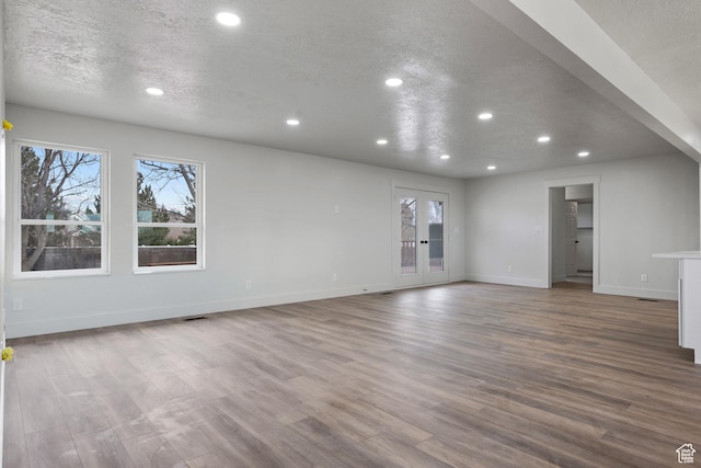 1455 E 100 S, Spanish Fork, UT 84660 - unfurnished living room featuring wood finished floors, recessed lighting, french doors, and a textured ceiling