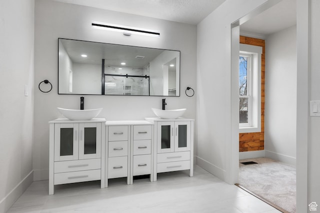 1455 E 100 S, Spanish Fork, UT 84660 - bathroom with a sink, baseboards, double vanity, and a shower stall