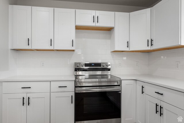 1455 E 100 S, Spanish Fork, UT 84660 - kitchen with backsplash, stainless steel electric range, white cabinets, and light countertops