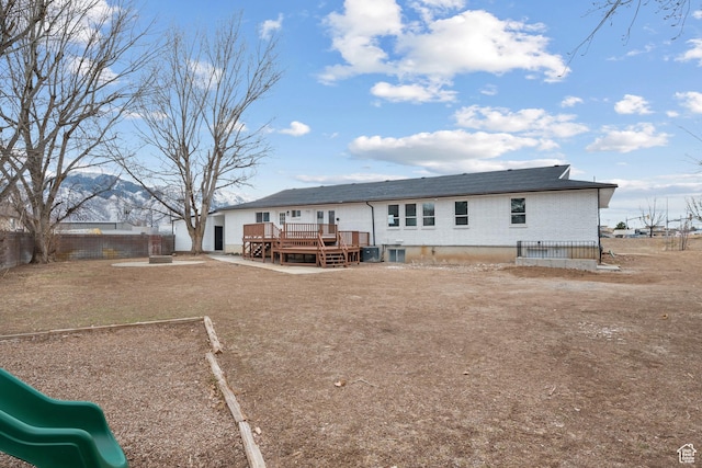1455 E 100 S, Spanish Fork, UT 84660 - rear view of house with a deck, a playground, a fenced backyard, and brick siding
