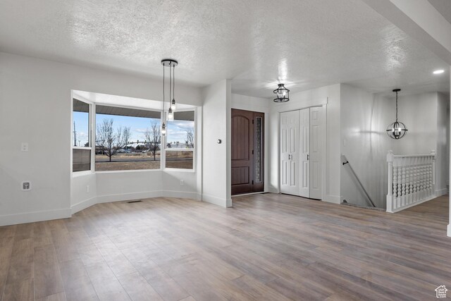 1455 E 100 S, Spanish Fork, UT 84660 - foyer with a textured ceiling, wood finished floors, baseboards, and a chandelier