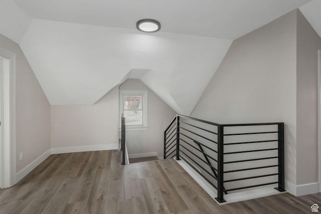 bonus room featuring vaulted ceiling and hardwood / wood-style flooring