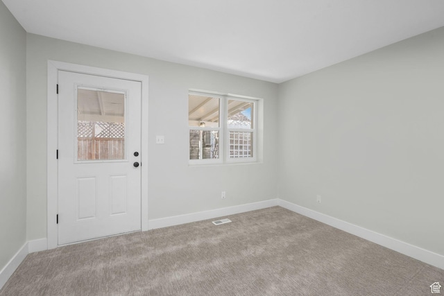 entryway featuring light carpet
