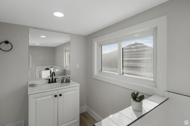 bathroom featuring vanity and hardwood / wood-style flooring