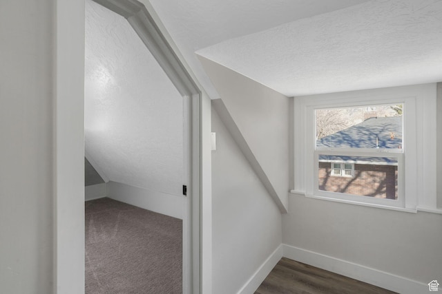 bonus room with a textured ceiling and lofted ceiling