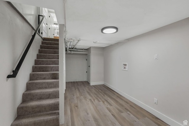 stairway with hardwood / wood-style floors