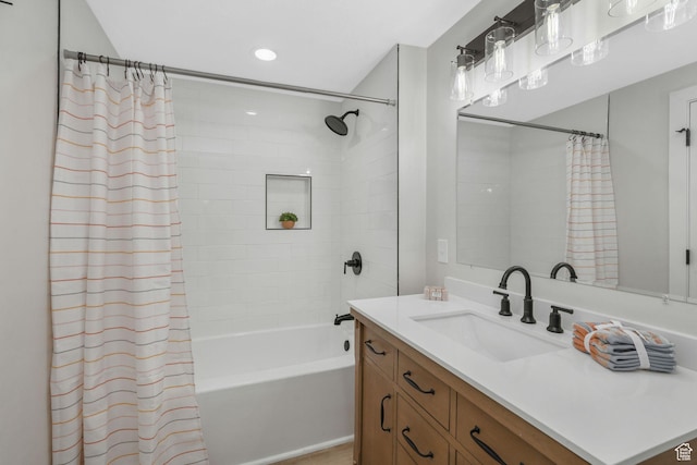 bathroom featuring shower / bath combo and vanity