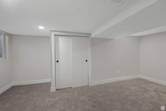 basement featuring light colored carpet