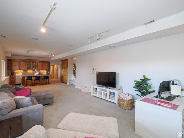 2960 E Oak Park Ln S, Holladay, UT 84117 - living room with visible vents, rail lighting, light colored carpet, and stairway