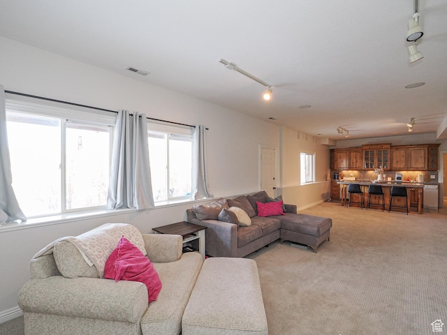 2960 E Oak Park Ln S, Holladay, UT 84117 - living room featuring visible vents, light colored carpet, rail lighting, and plenty of natural light