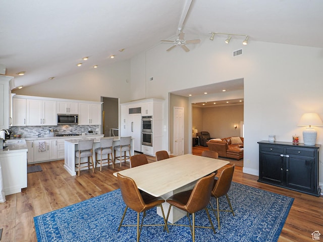 2960 E Oak Park Ln S, Holladay, UT 84117 - dining room with high vaulted ceiling, visible vents, light wood-type flooring, and ceiling fan