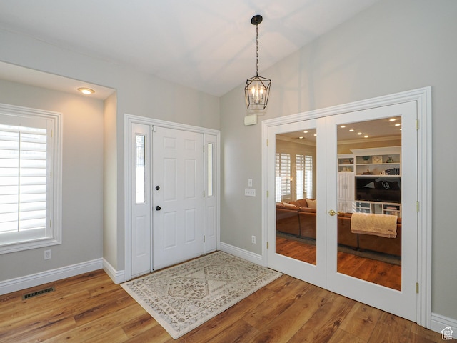 2960 E Oak Park Ln S, Holladay, UT 84117 - foyer entrance with french doors, visible vents, a notable chandelier, and wood finished floors