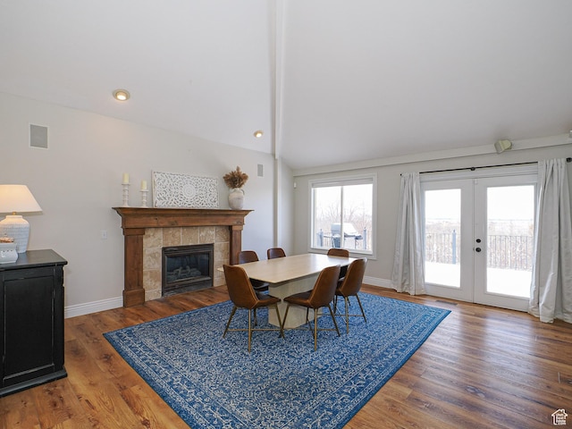 2960 E Oak Park Ln S, Holladay, UT 84117 - dining space with baseboards, vaulted ceiling, a fireplace, french doors, and wood finished floors