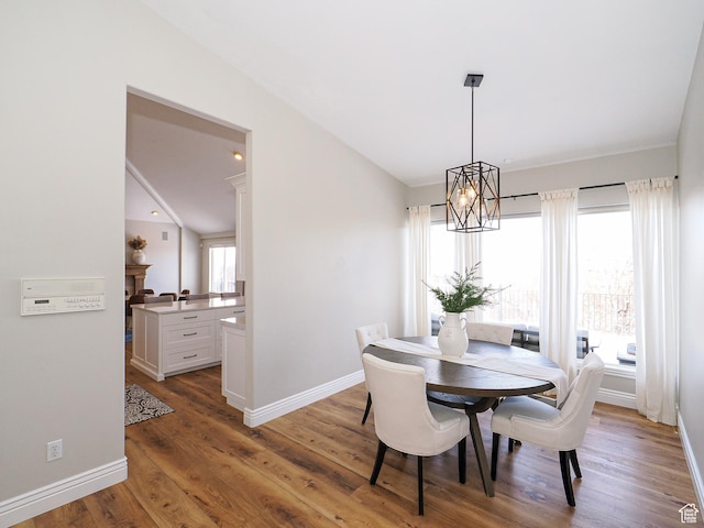 2960 E Oak Park Ln S, Holladay, UT 84117 - dining space featuring lofted ceiling, baseboards, an inviting chandelier, and wood finished floors