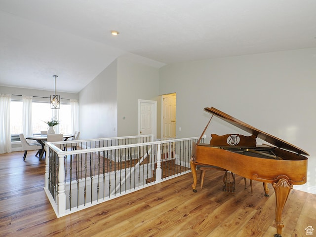 2960 E Oak Park Ln S, Holladay, UT 84117 - sitting room featuring wood finished floors, vaulted ceiling, and an upstairs landing