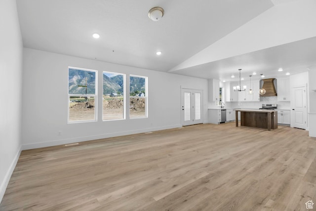 1471 S 130 W Unit 37, Salem, UT 84653 - unfurnished living room featuring light wood-type flooring, lofted ceiling, and sink