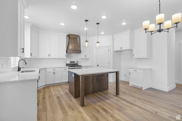 1471 S 130 W Unit 37, Salem, UT 84653 - kitchen featuring pendant lighting, stainless steel range oven, white cabinetry, premium range hood, and sink