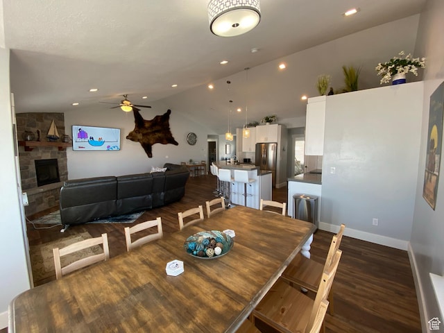 37 Wedge Way, Garden City, UT 84028 - dining space with lofted ceiling, ceiling fan, dark hardwood / wood-style flooring, and a stone fireplace