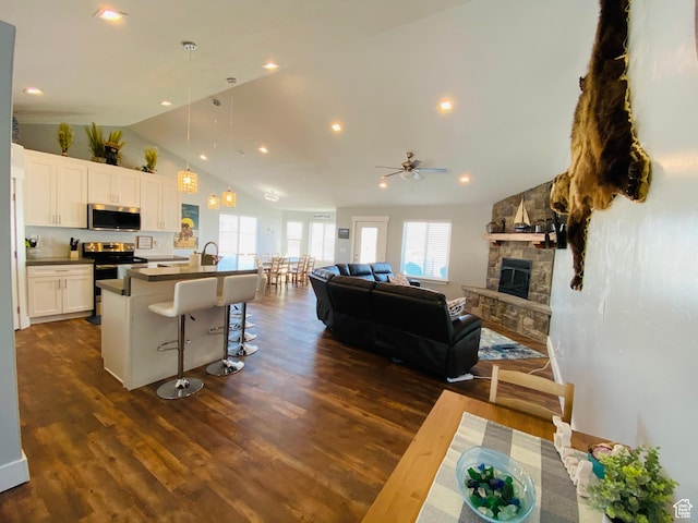 37 Wedge Way, Garden City, UT 84028 - kitchen with white cabinetry, an island with sink, a breakfast bar area, stainless steel appliances, and ceiling fan
