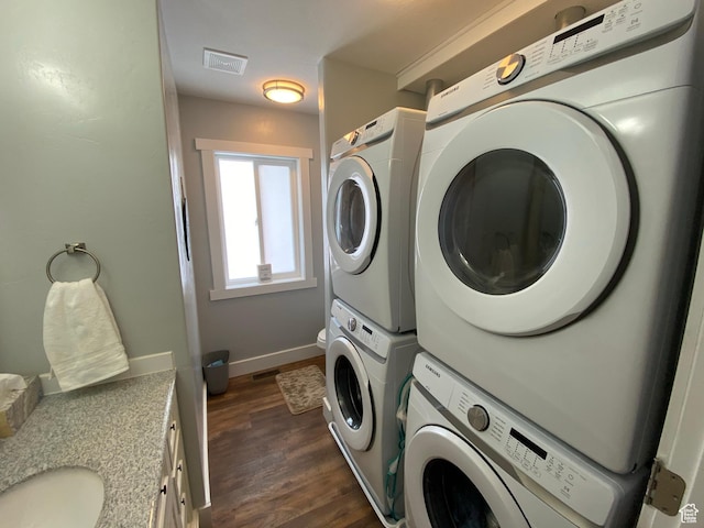 37 Wedge Way, Garden City, UT 84028 - clothes washing area with stacked washing maching and dryer, dark wood-type flooring, and sink