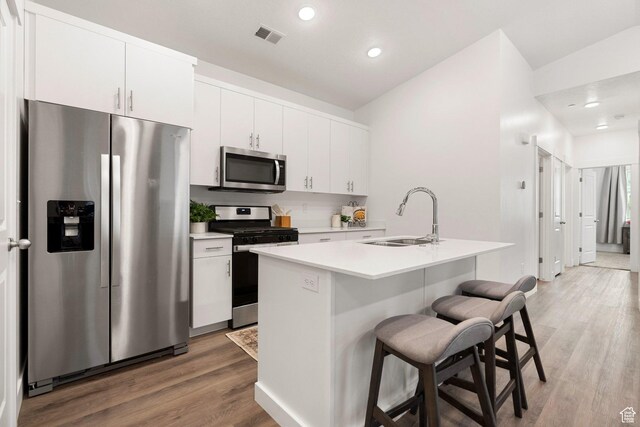 460 W 15 S Unit G301, Providence, UT 84332 - kitchen featuring stainless steel appliances, a sink, a breakfast bar, recessed lighting, and light wood-style flooring